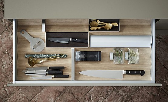 Drawer organization 1: foil roll holders and spice jars – everything is fitted perfectly into the wooden prisms 